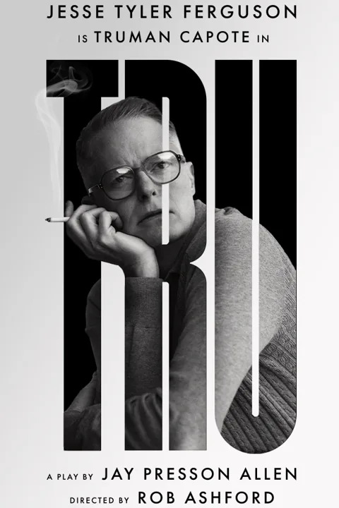 Jesse Tyler Ferguson as Truman Capote sits at desk in Tru at the Menier Chocolate Factory