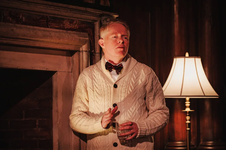 Jesse Tyler Ferguson as Truman Capote by the fireplace with a drink, Tru, Menier Chocolate Factory